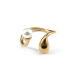 Elegant gold ring with a droplet design and a fine pearl, embodying minimalist beauty and unique style.