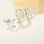 Сребърни обеци с камъни, комплект от три броя, с модерен дизайн и изящен блясък.