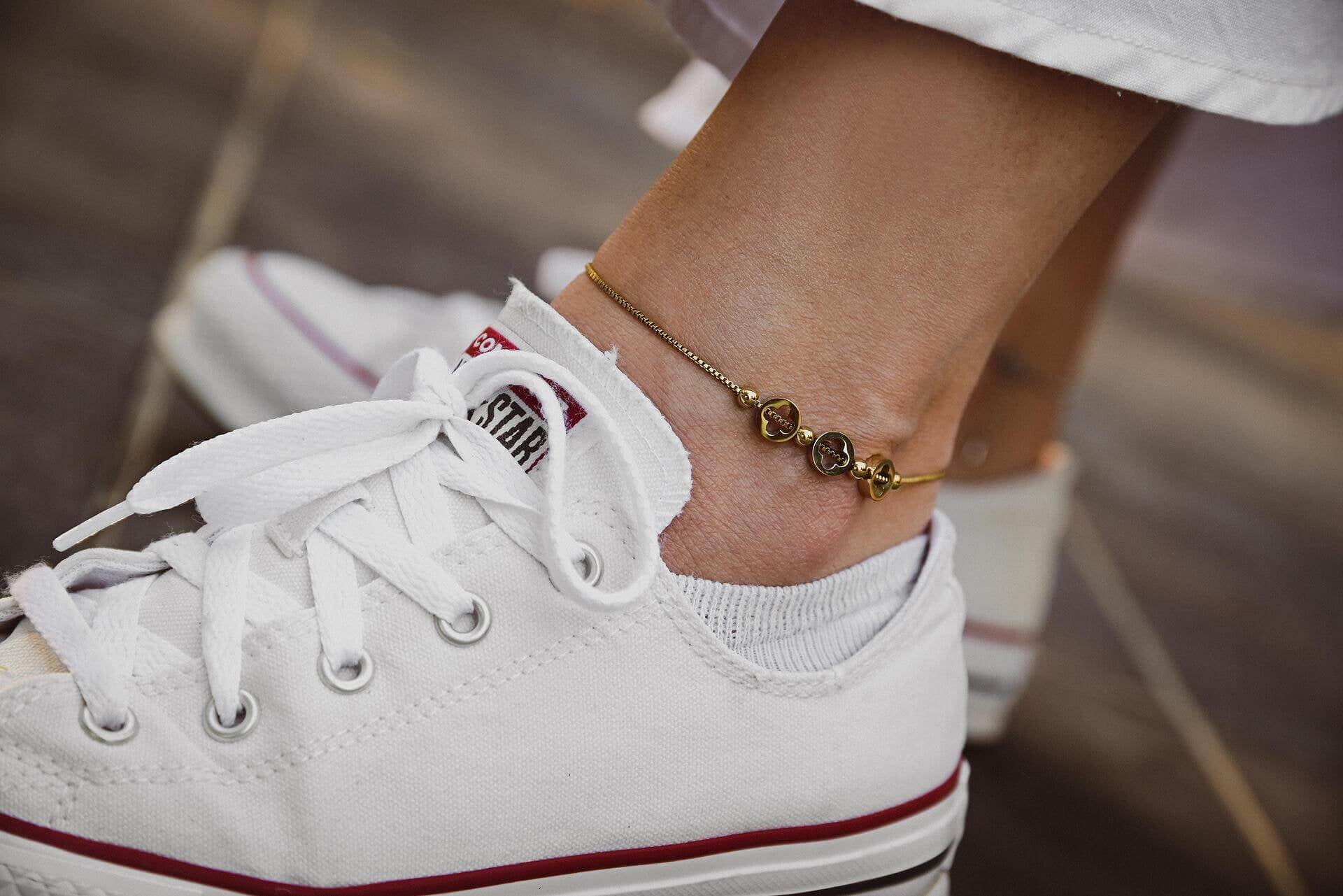 Гривна за глезен от медицинска стомана, модерна и елегантна, в комплект със спортни обувки.